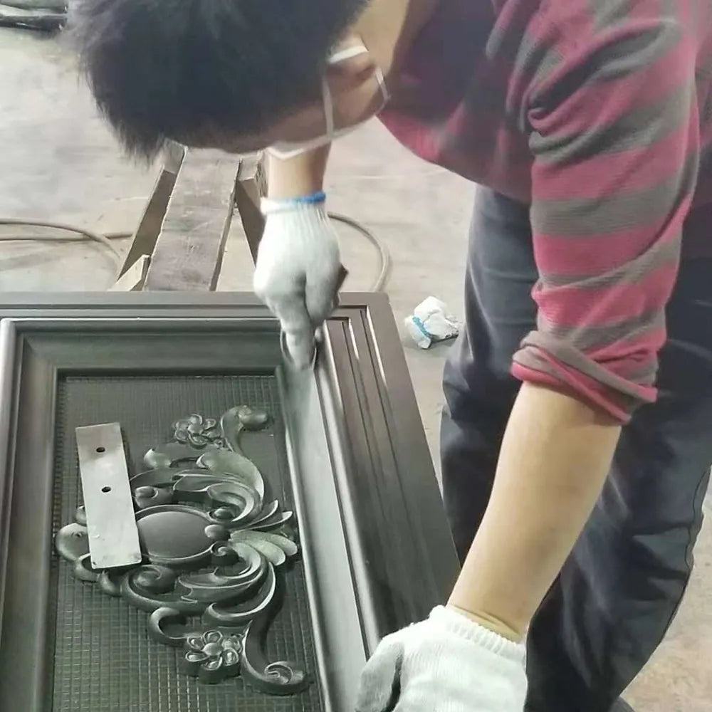 Gloved hands lifting a door panel with cast ornament