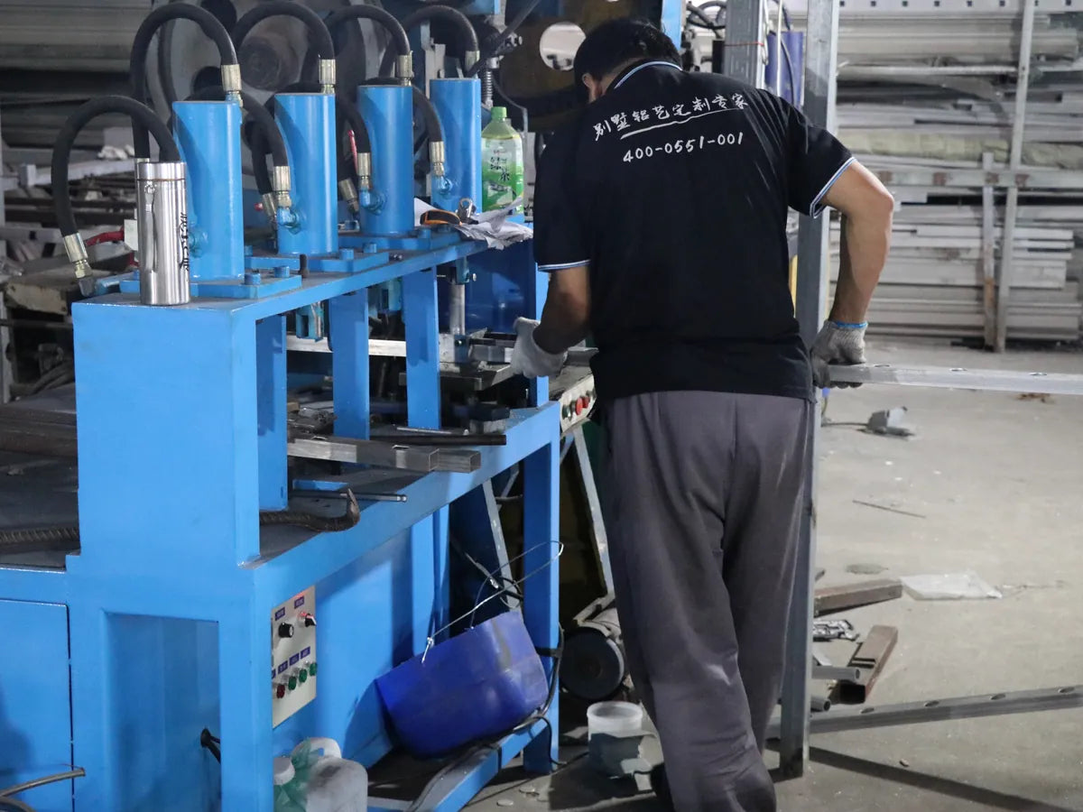 A worker at the punching press